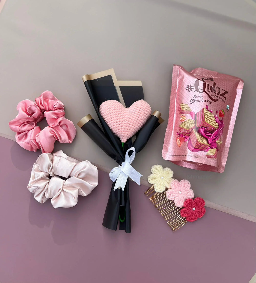 Gift set with pink and cream scrunchies, heart bouquet, floral hair comb, and strawberry wafers