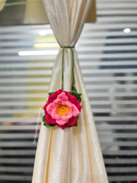 Handcrafted crochet flower curtain tieback on cream curtain in modern room