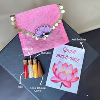 Diwali puja kit with a pink pouch, arti booklet, roli, chawal, chandan, and rose dhoop cone